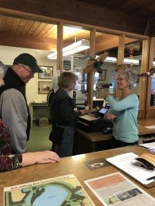 Resource Center Volunteers recieving cash register instruction