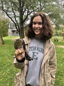 Photo of Mary Cook holding an immature Sharp-shinned Hawk